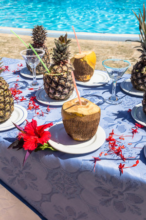 Table full of tropical drinks near the pool. Pina colada, coconut drink.の写真素材