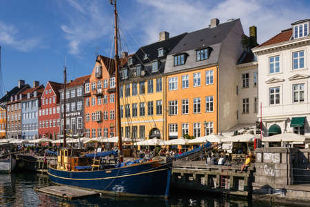 Scenic summer view of Nyhavn pier with colorful buildings and boats in Old Town of Copenhagen, Denmarkの写真素材