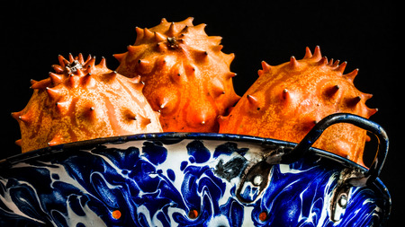 Horned melon in an antique colanderの写真素材