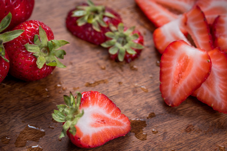 Strawberries on dark wood cutting board
