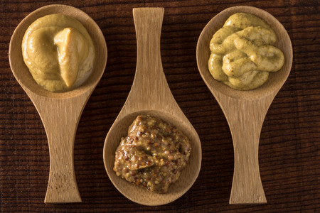 Honey Mustard, Stone Ground Mustard, and Brown Spicy Mustardの写真素材