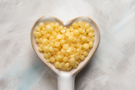 Beeswax Pellets in a Heart Shape Spoonの写真素材