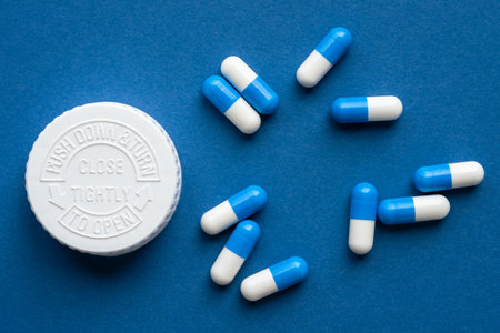 Blue and White Capsules and a Bottle Cap