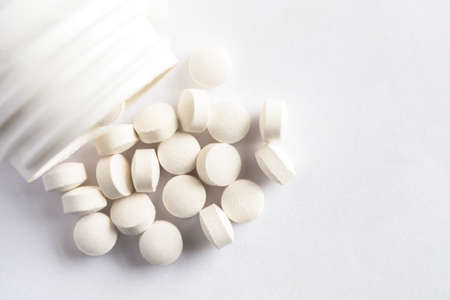 Vitamin D Supplements Spilled from a Bottle