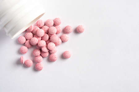 Vitamin B12 Supplements Spilled from a Bottleの写真素材