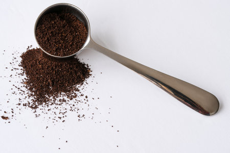 Ground Coffee Beans Spilled from a Scoopの写真素材