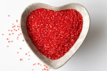 Red Sprinkles in a Heart Shaped Bowlの写真素材