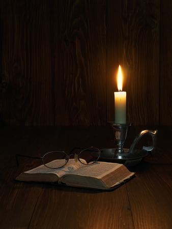 Reading the bible by candlelightの写真素材