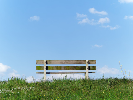 Park bench on a riverside in the Netherlandsの写真素材