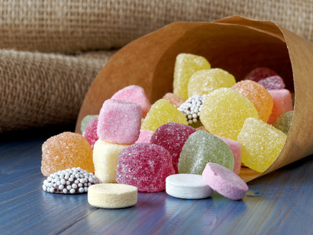 Paper bag filled with sugar candy sweetsの写真素材