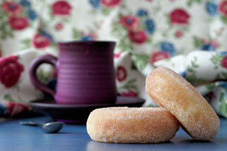 Donuts with purple coffee cup in the backgroundの写真素材