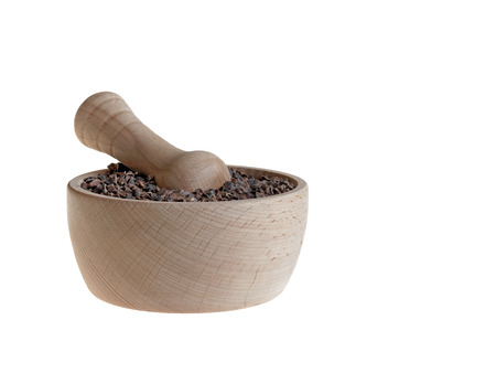 Organic cacao nibs in pestle isolated on whiteの写真素材