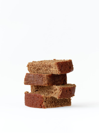 Stack of homemade gingerbread slices isolated on whiteの写真素材