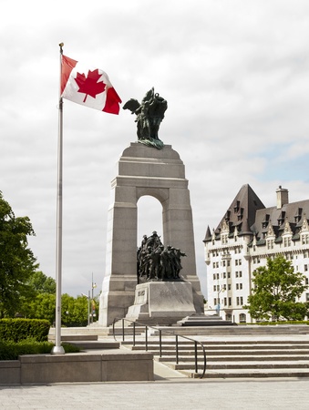 The National War Memorial with Canadian flag and the Fairmont Chateau Laurier in Ottawa, Canada の写真素材