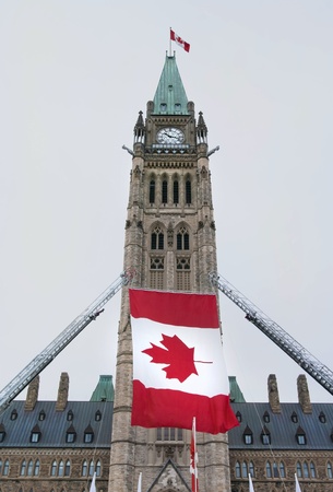 The canadian Parliament Centre block with canadian flags during a celebration の写真素材