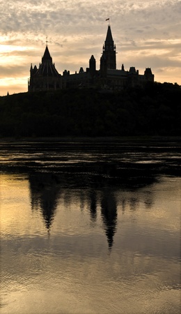 The canadian Parliament reflecting in the Ottawa river at sunrise の写真素材
