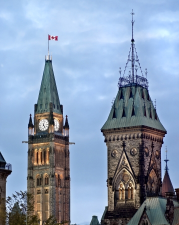 The Canadian Parliament Centre and East Blocks with the Maple Leaf flag in Ottawa, Ontario, Canada の写真素材