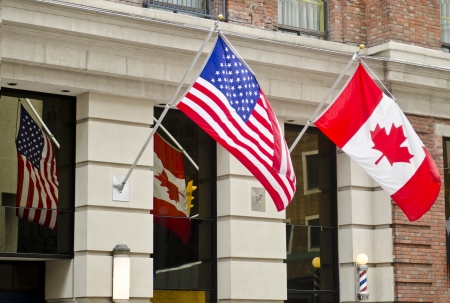 The Canadian and United States of America flags are waving proudly side by side in Ottawa, Canada の写真素材