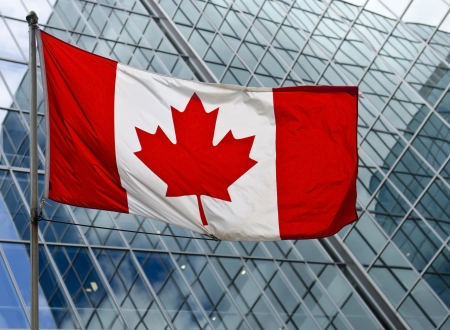 The Canadian flag against a high rise building in downtown Ottawa, Canada の写真素材