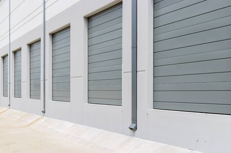 Empty warehouse loading dock white walls gray metal sliding doors