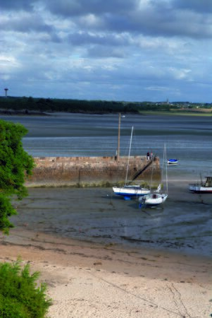 boat lying on the sand at low tide at Saint-Jacut-de-la-Mer, in Brittanyの写真素材