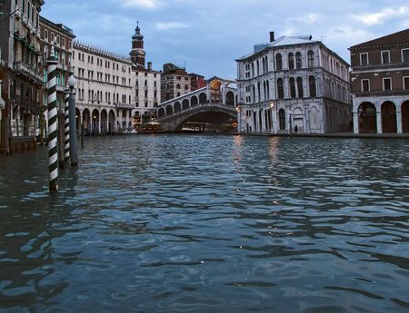 Blue water of Venice with old palaces and Rialto bridge at backgroundの写真素材