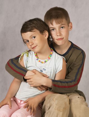 Brother hug a Sister Sitting On Couchの写真素材