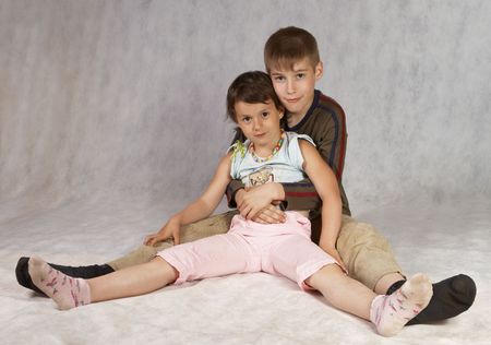 boy and girl riends sit together and hugsの写真素材