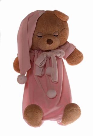 Isolated teddy bear slipping at white background. Soft children toy in pajamasの写真素材