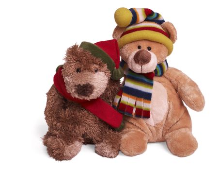 Isolated teddy bear couple sitting at white background. Friends in winter clothingの写真素材