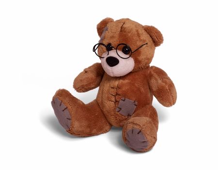 Isolated teddy bear sitting at white background. Soft children toy in glassesの写真素材