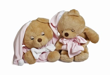 Isolated teddy bear couple sitting at white background. Couple in sleeping clothingの写真素材