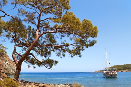 ship in blue mediterranian bay at a sunny dayの写真素材