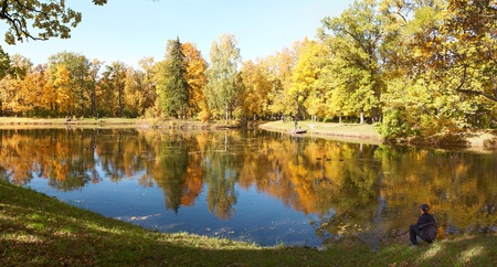 Teen Enjoys the Fall Alone near waterの写真素材