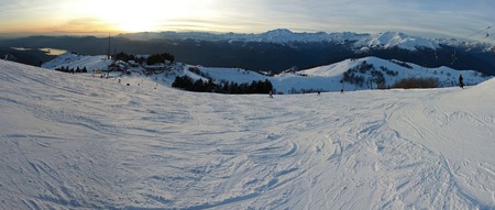 down the slope at sunset Monterone ski area in Italyの写真素材