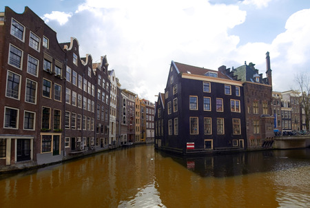 Old Houses and canals at Amsterdam center in cloudy day. Netherlandsのeditorial素材