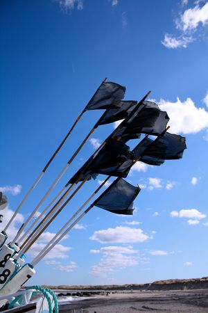 Black flags of a fishing boatの写真素材