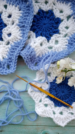 Blue, white crochet elements and orchid. Crochet texture, place for an inscription, adapted for mobileの写真素材