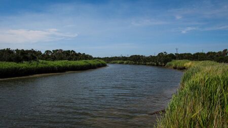 Wide and long river bend at Inverloch, VIC, Australia. The river banks are planked by lush...