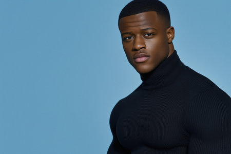 Close-up portrait of a man in a black turtleneck with a blue background. Professional modern styling.の素材