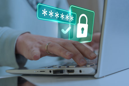 Cyber security concept with hands typing on laptop and glowing lock icon