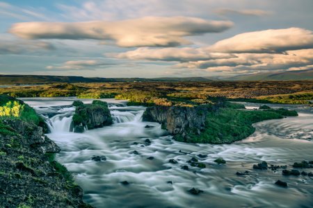 Waterfall cascading over rocky terrainの写真素材
