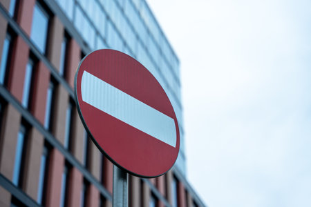 Do not enter road sign with modern building background