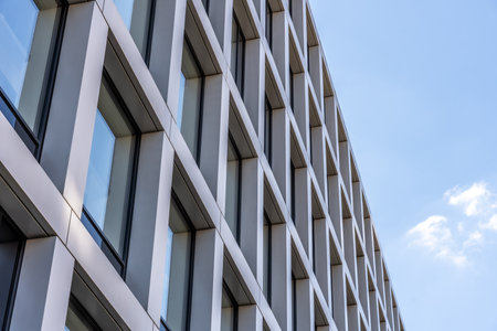 Angled view of minimalist building facade with sleek vertical and horizontal lines, urban design and...