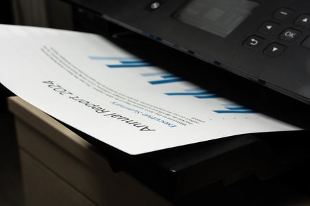 Closeup of printed business document emerging from office printer, concept of financial reporting...