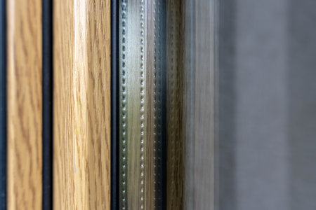 Detailed shot of triple glazed window frame with wooden and metal components, showing insulation spacer and layered materials, building technology conceptの写真素材