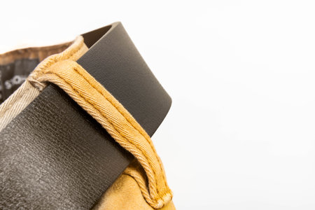 Close-up of brown pants with textured fabric and dark brown leather belt in minimal studio light, fashion detail and clothing designの写真素材