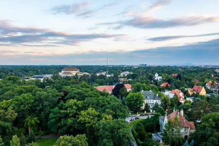 Drone view of lush suburban neighborhood with iconic Centennial Hall under cloudy summer skyの写真素材