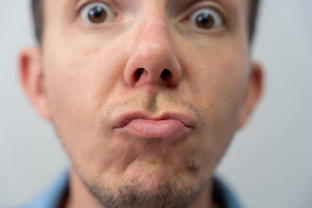 Man Lips Mouth Closeup Face With Pout Expression, Funny Emotion Detail And Skin Texture Macro Portraitの写真素材