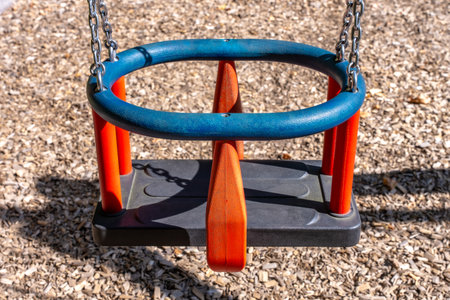 Toddler Swing Seat With Safety Chain, Blue And Red Outdoor Playground In Parkの写真素材